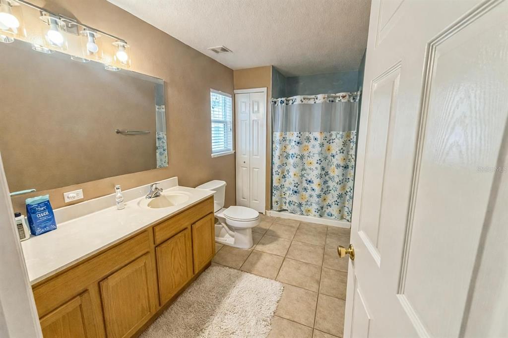 217 Tres Reyes Lane Groveland, FL 34736 - Photo 9 of 20 a bathroom with a sink a toilet and shower