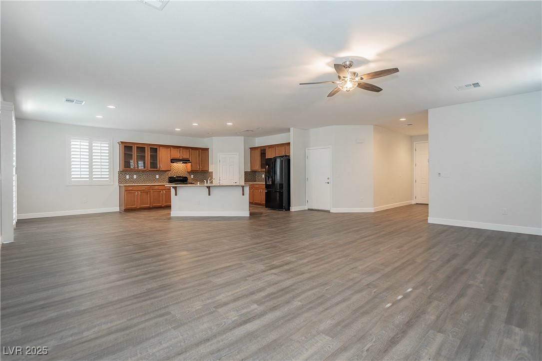 971 Huntington Cove Parkway Las Vegas, NV 89178 - Photo 12 of 55 Unfurnished living room featuring ceiling fan, recessed lighting, and dark wood-style flooring