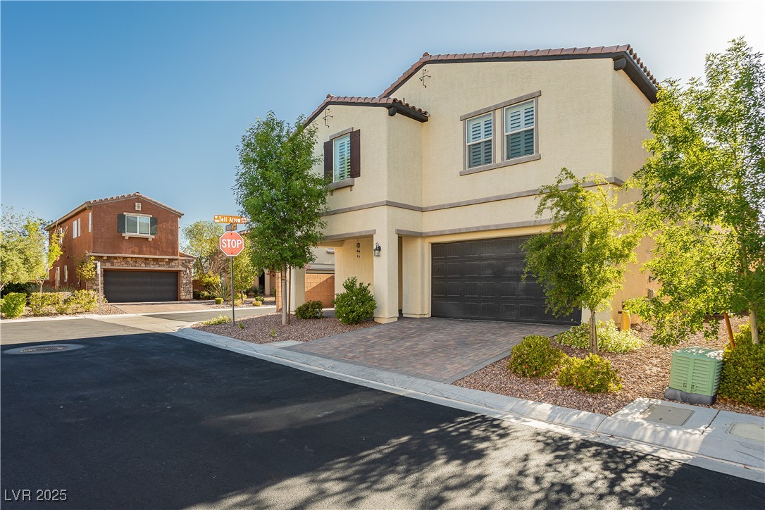 971 Huntington Cove Parkway Las Vegas, NV 89178 - Photo 3 of 55 Mediterranean / spanish home with a garage, driveway, stucco siding, and a tile roof