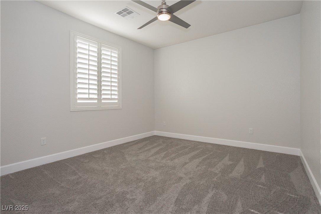 971 Huntington Cove Parkway Las Vegas, NV 89178 - Photo 31 of 55 Spare room with ceiling fan and carpet