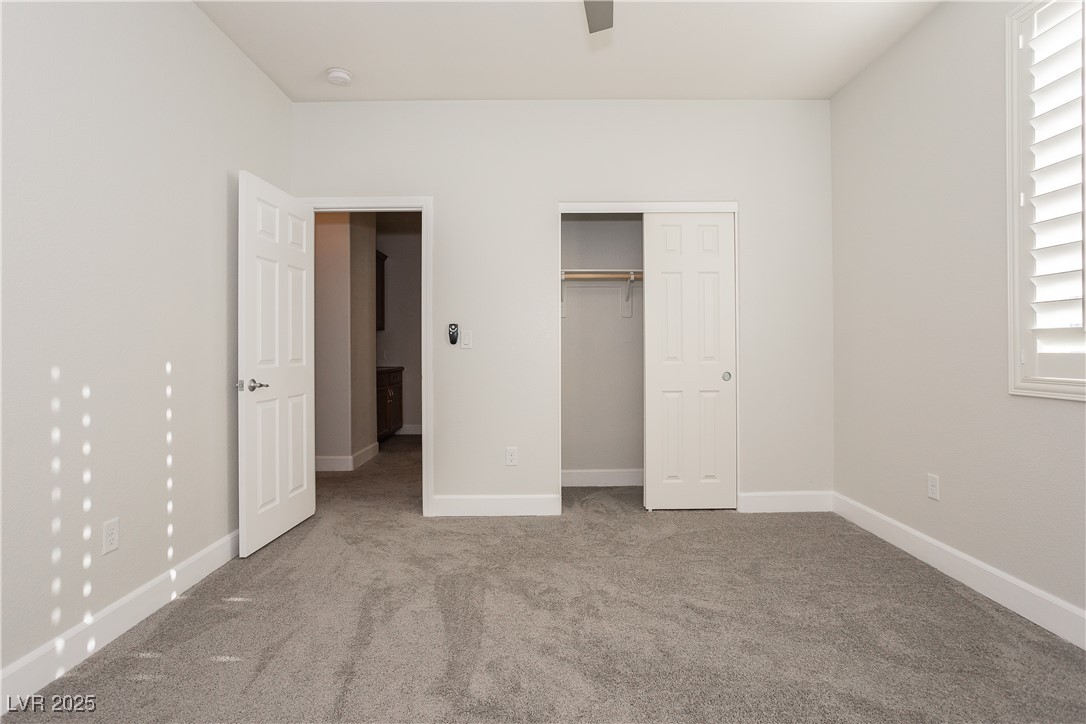 971 Huntington Cove Parkway Las Vegas, NV 89178 - Photo 32 of 55 Unfurnished bedroom featuring carpet floors and a closet
