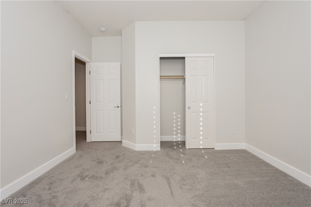 971 Huntington Cove Parkway Las Vegas, NV 89178 - Photo 34 of 55 Unfurnished bedroom featuring carpet and a closet