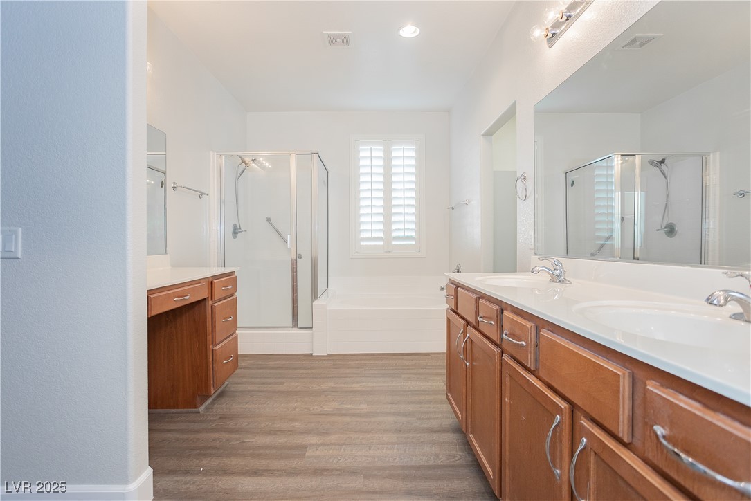 971 Huntington Cove Parkway Las Vegas, NV 89178 - Photo 43 of 55 Full bath with a stall shower, double vanity, wood finished floors, and a bath