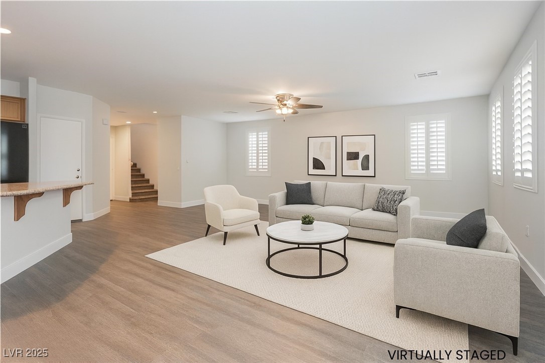 971 Huntington Cove Parkway Las Vegas, NV 89178 - Photo 9 of 55 Living area featuring light wood finished floors, stairs, and a ceiling fan
