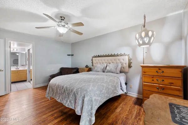 a spacious bedroom with a bed and a table in it