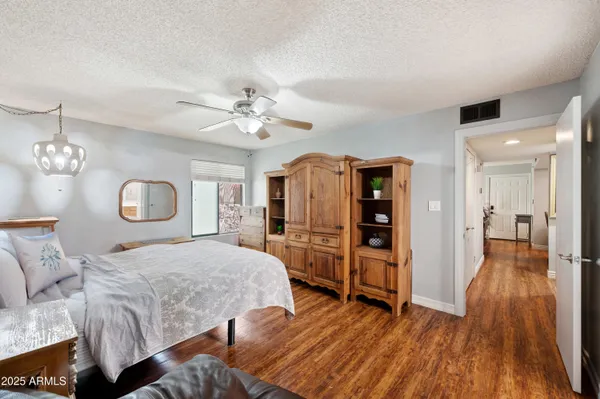 a bedroom with furniture and wooden floor