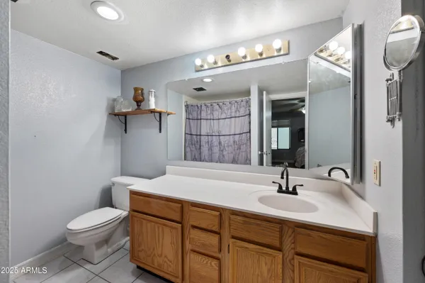 a bathroom with double vanity and a shower