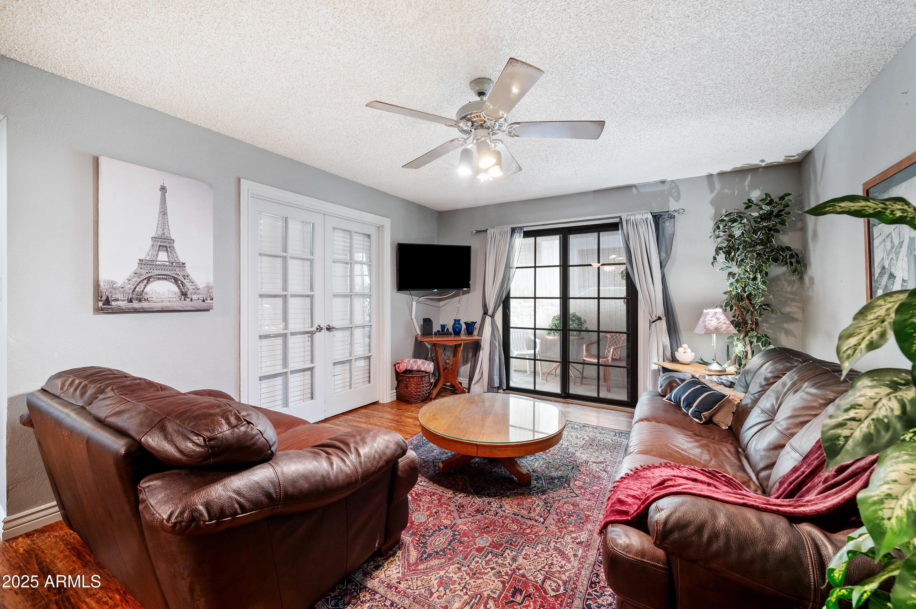 5518 East Lindstrom Lane, Unit 1011 Mesa, AZ 85215 - Photo 4 of 32 a living room with furniture a chandelier and a window