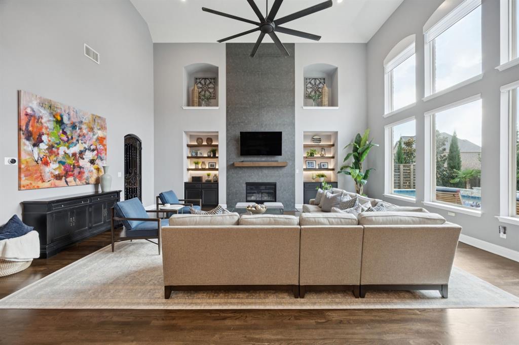 7121 Calypso Lane Frisco, TX 75036 - Photo 12 of 40 a living room with fireplace furniture and a flat screen tv