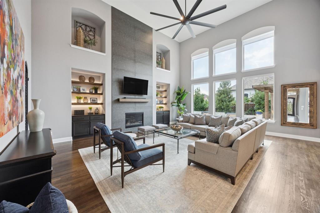 7121 Calypso Lane Frisco, TX 75036 - Photo 13 of 40 a living room with furniture a flat screen tv and a fireplace