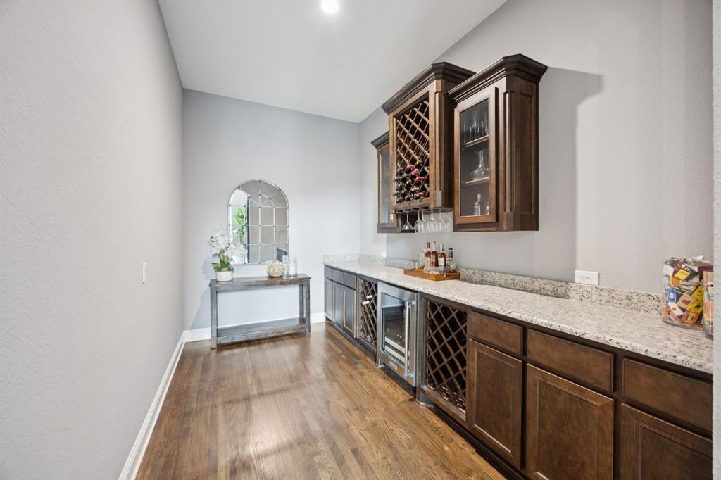 7121 Calypso Lane Frisco, TX 75036 - Photo 15 of 40 a large white kitchen with a sink and dishwasher a stove with wooden floor