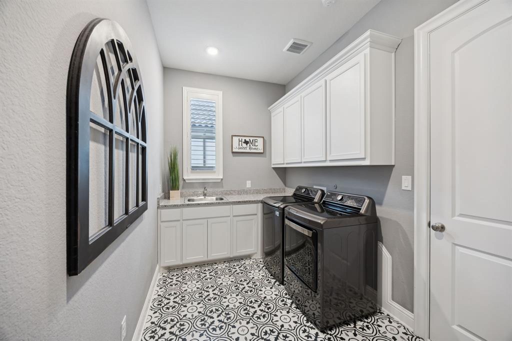 7121 Calypso Lane Frisco, TX 75036 - Photo 21 of 40 a kitchen with stainless steel appliances granite countertop a stove a sink and a refrigerator