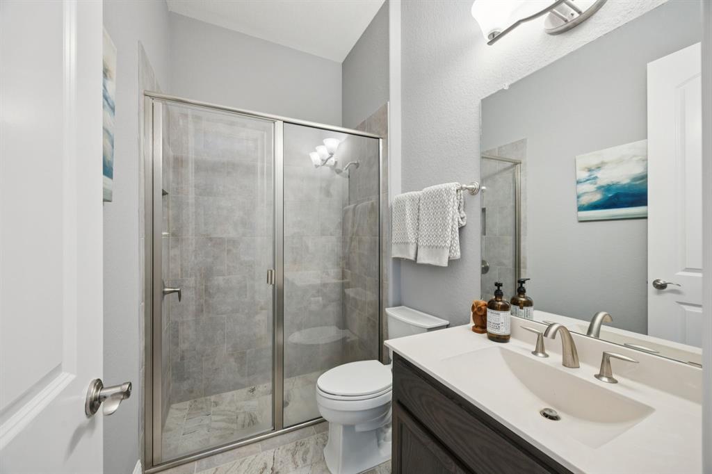 7121 Calypso Lane Frisco, TX 75036 - Photo 23 of 40 a bathroom with a sink toilet and shower