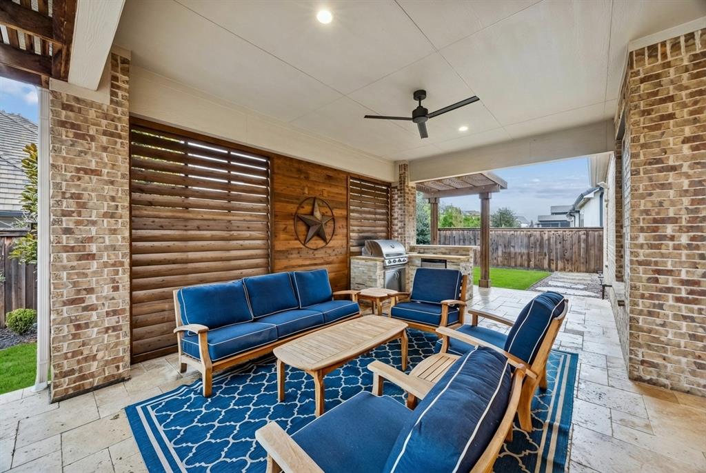 7121 Calypso Lane Frisco, TX 75036 - Photo 33 of 40 a living room with furniture a rug and a floor to ceiling window
