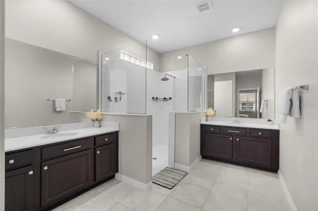 a spacious bathroom with a granite countertop sink mirror and a