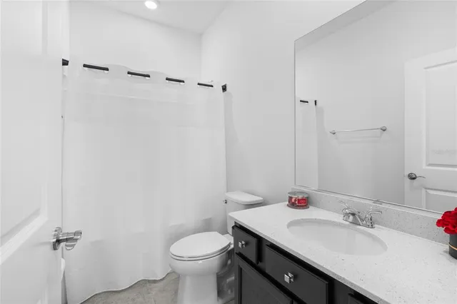 a bathroom with a sink toilet and a mirror