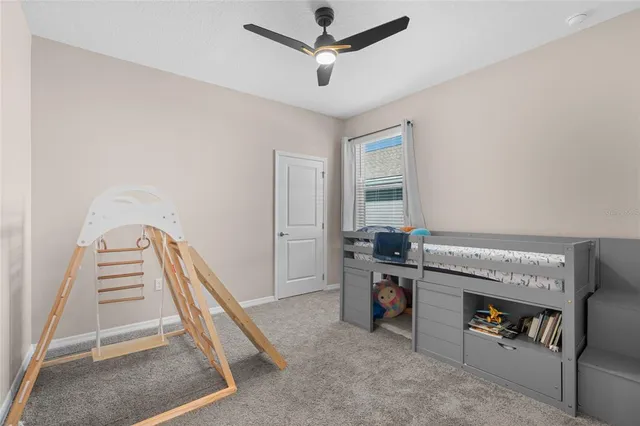 a view of workspace with furniture and ceiling fan