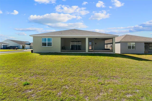 a view of a house with swimming pool in front of it