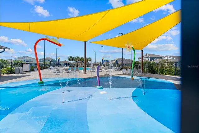 a swimming pool with outdoor seating and yard