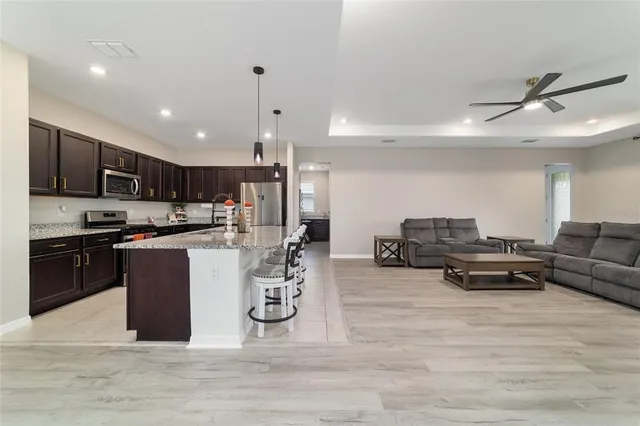 a kitchen with a refrigerator and a stove top oven