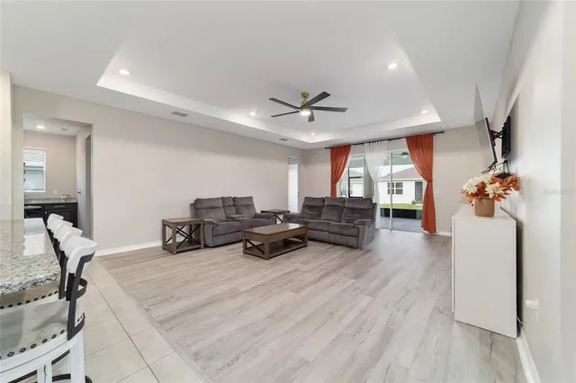 a living room with furniture a fireplace and a chandelier