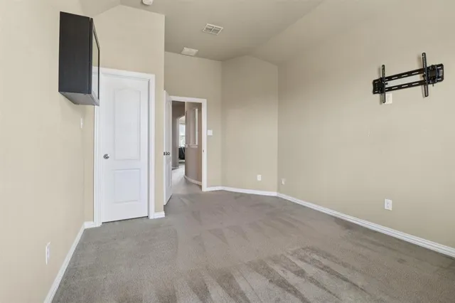 an empty room with a empty space and a flat screen tv