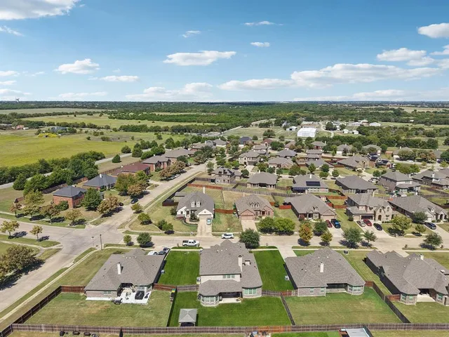 an aerial view of residential houses with outdoor space