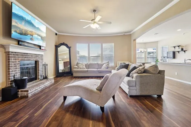 a living room with furniture fireplace and window