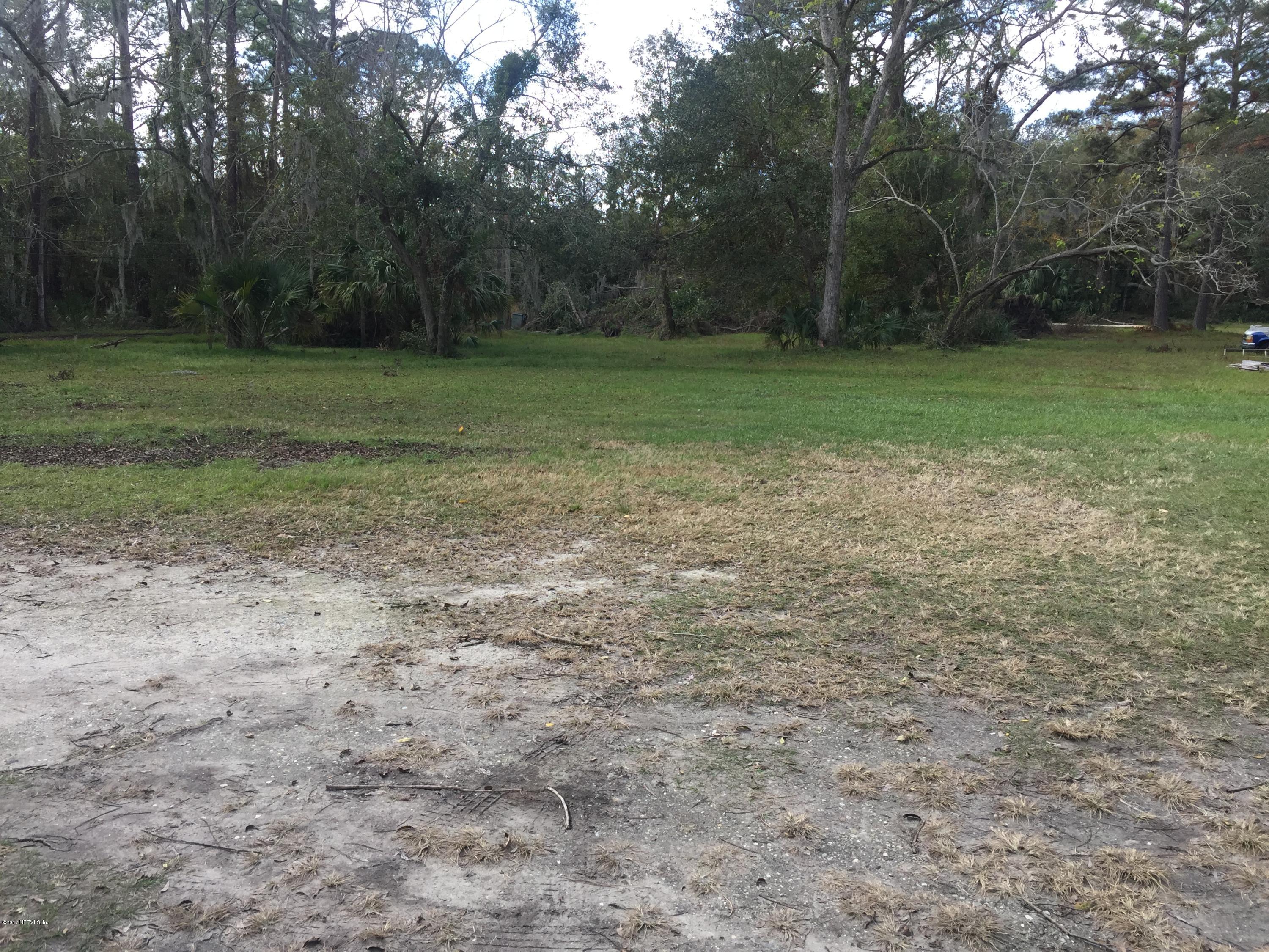 4527 Fennell Road Jacksonville, FL 32244 - Photo 16 of 38 a view of a field with trees in background
