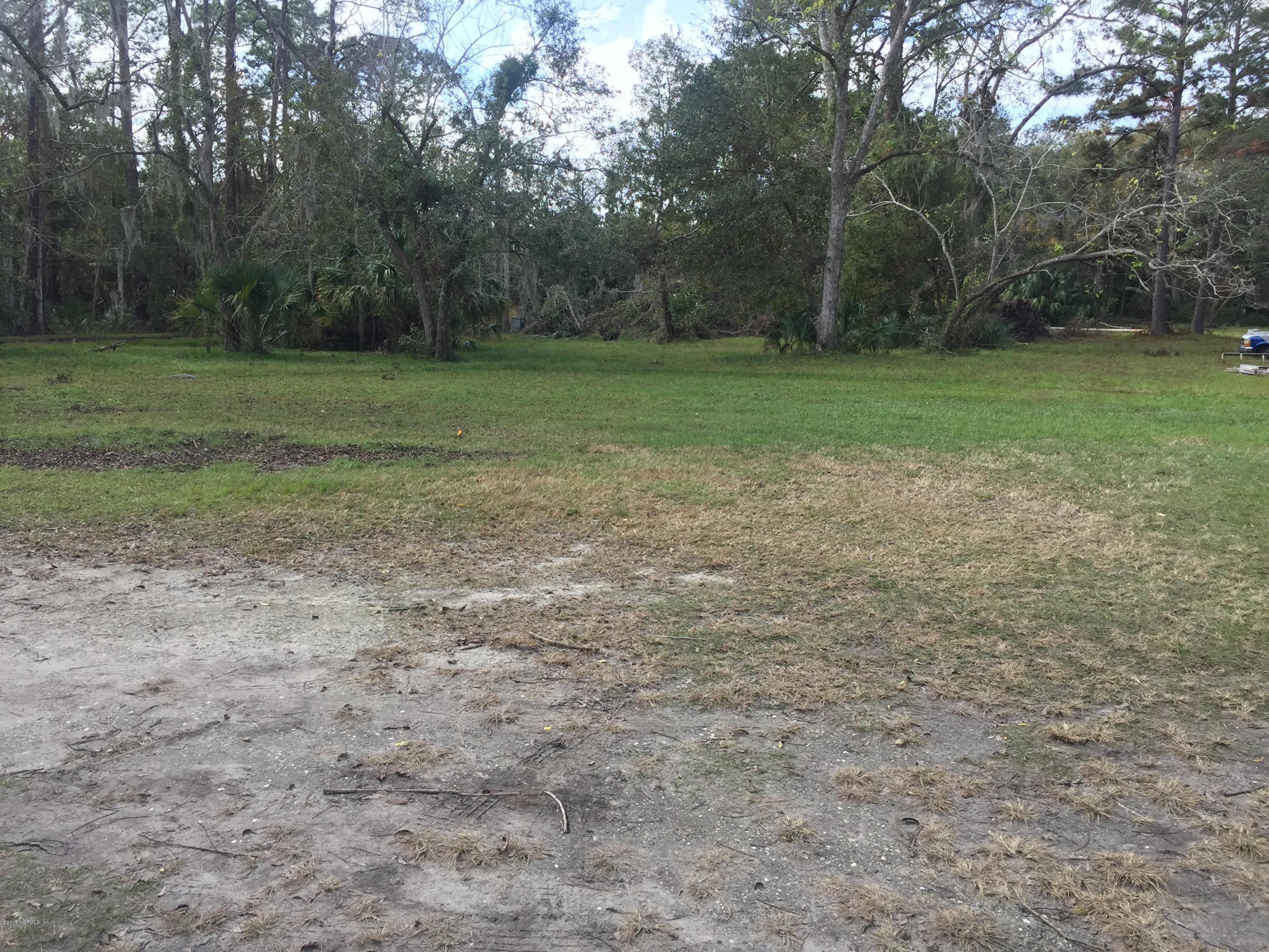 4527 Fennell Road Jacksonville, FL 32244 - Photo 17 of 38 a view of a field with trees in background
