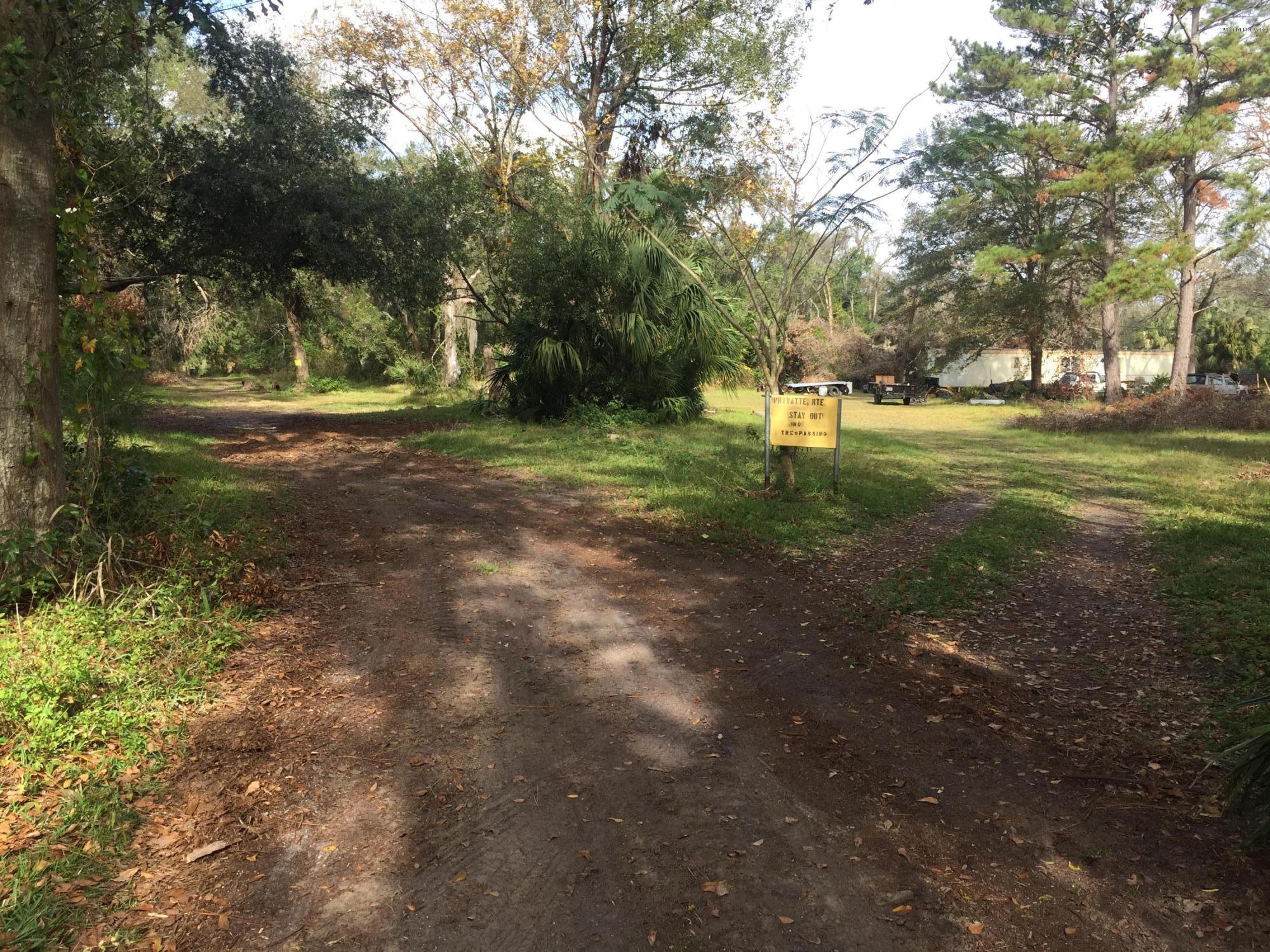 4527 Fennell Road Jacksonville, FL 32244 - Photo 22 of 38 a view of a tree in the middle of a yard