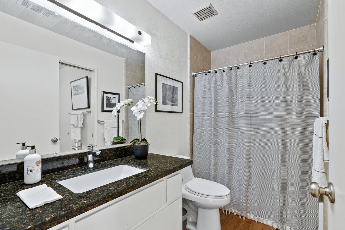 4207 Topsail Court Soquel, CA 95073 - Photo 11 of 19 a bathroom with a granite countertop sink and a mirror