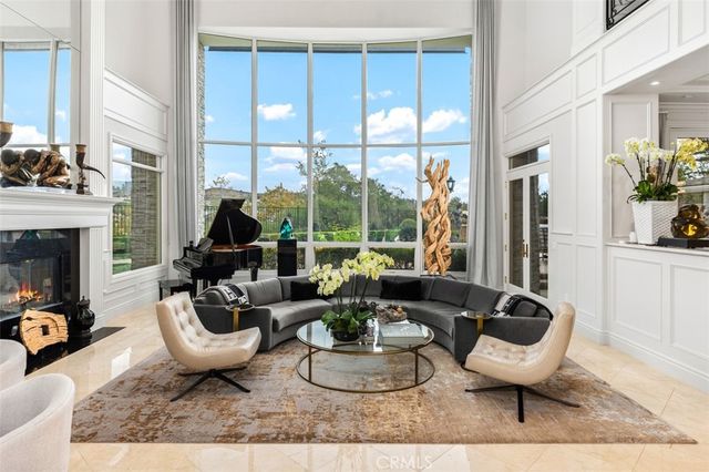 a living room with furniture a window and a fireplace