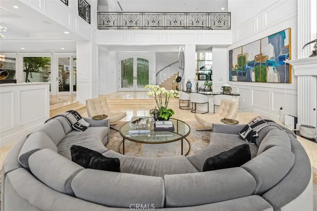 a living room with furniture and a large mirror