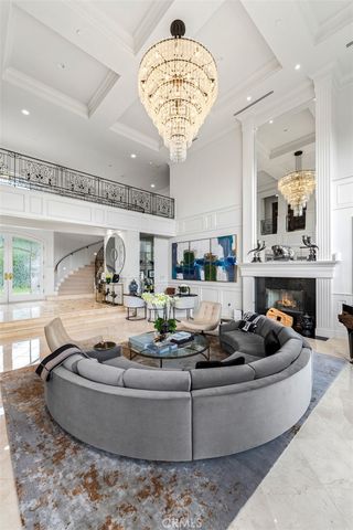 a living room with furniture and a chandelier