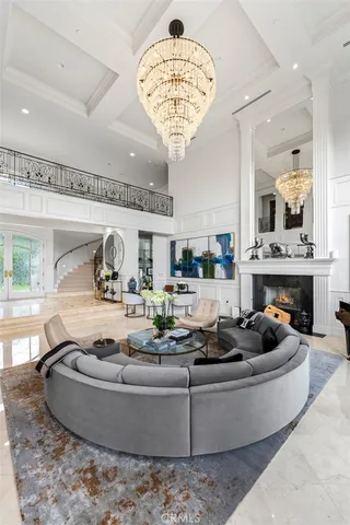 a living room with furniture and a chandelier