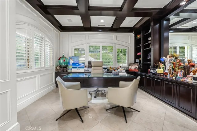 a dining room with furniture and a large window