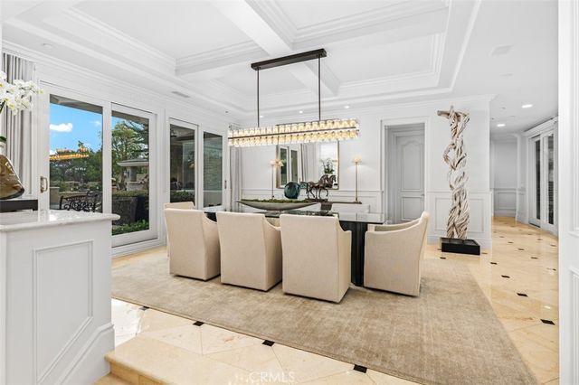 a living room with fireplace furniture and a chandelier