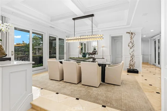a living room with fireplace furniture and a chandelier