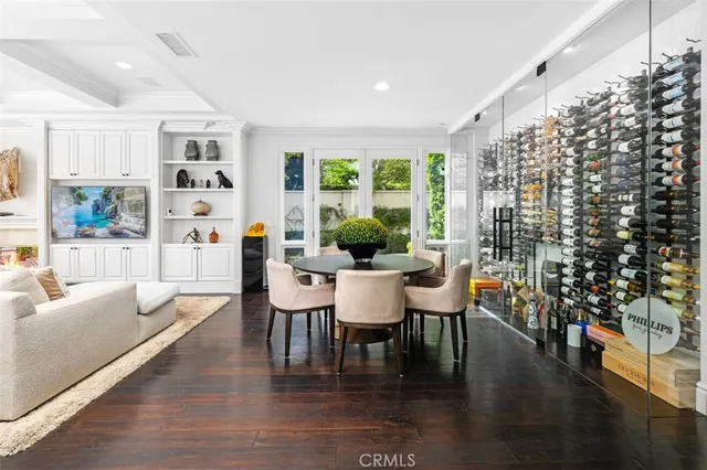 a dining room with furniture window and wooden floor