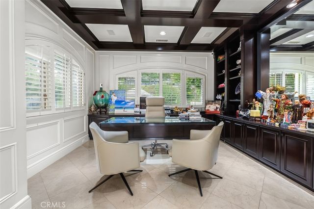 a dining room with furniture and a large window