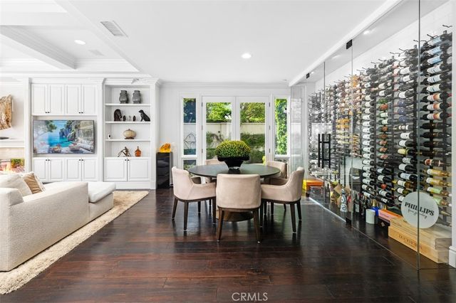 a dining room with furniture window and wooden floor