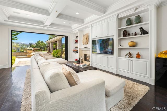 a living room with fireplace furniture and a flat screen tv