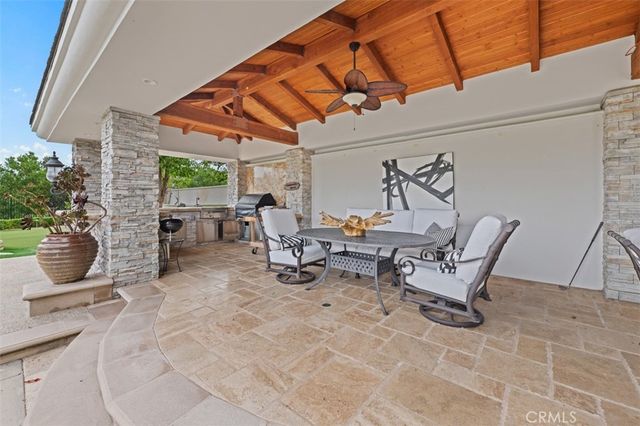 a view of a patio with table and chairs and potted plants