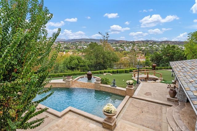 aerial view of a house with garden space and a patio