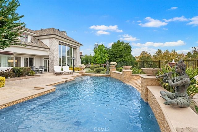a view of a white house with a swimming pool