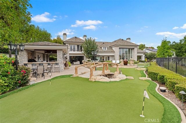 a view of a house with swimming pool and furniture