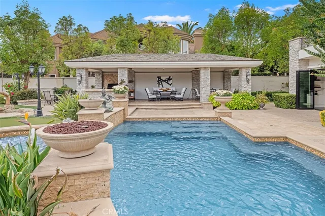 a view of a house with swimming pool and furniture