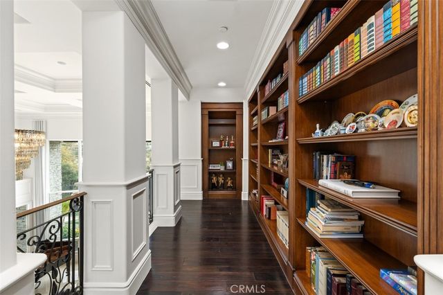 a bedroom with a bed and glass walk in closet
