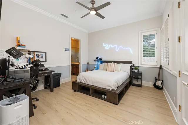 a bedroom with a bed and glass walk in closet